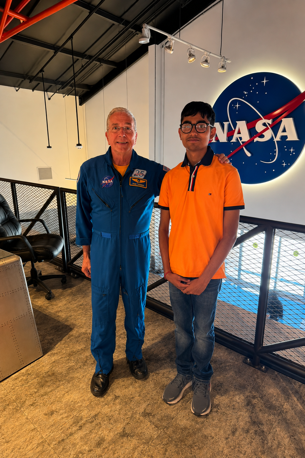 Adithya standing beside a NASA astronaut